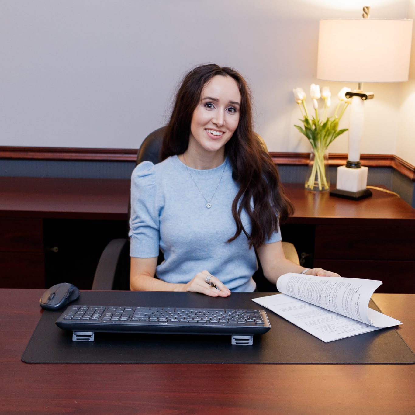 Dr. Chloe Skidmore at her desk, illustrating her individualized wellness strategy design through functional medicine and integrative health