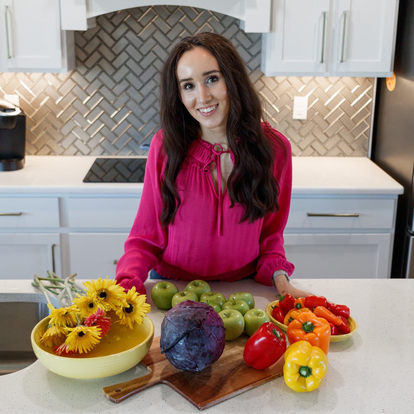 Dr. Chloe Skidmore with fresh produce, embodying her philosophy of comprehensive care for physical, emotional, and mental health on her practice